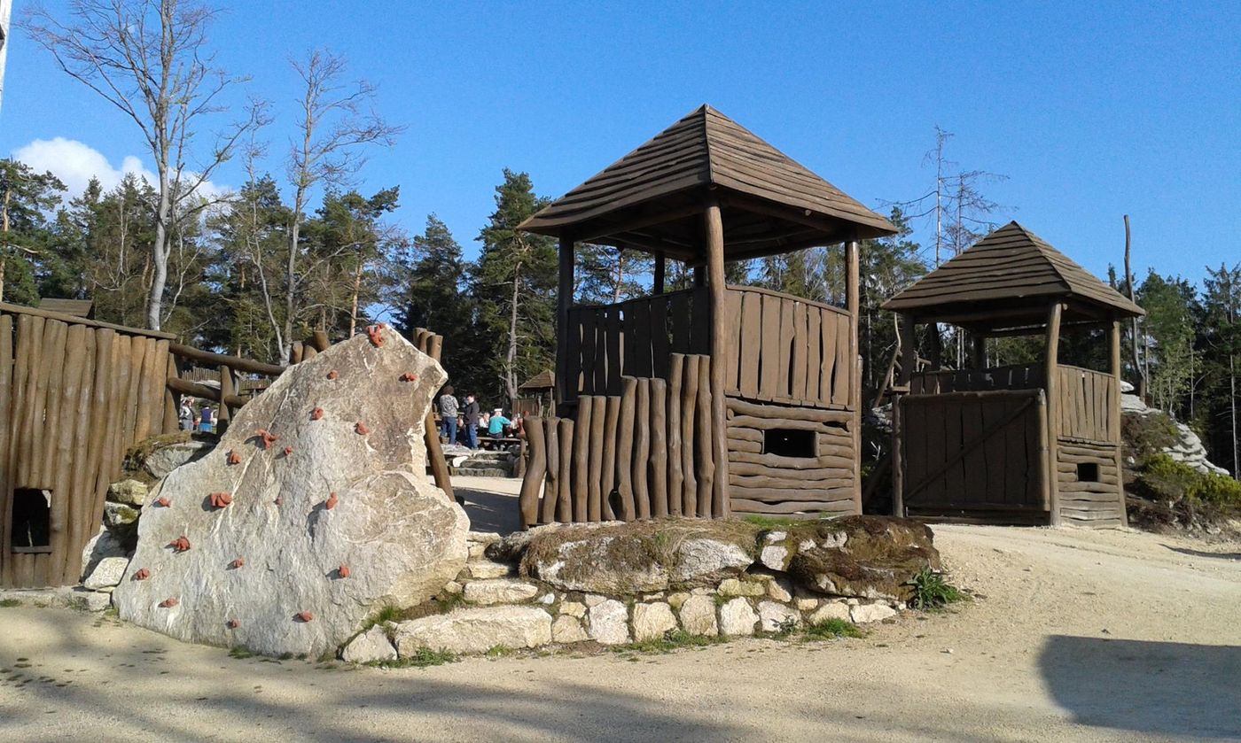 Dvě vyřezávané dřevěné strážní věže u vstupu do lesoparku